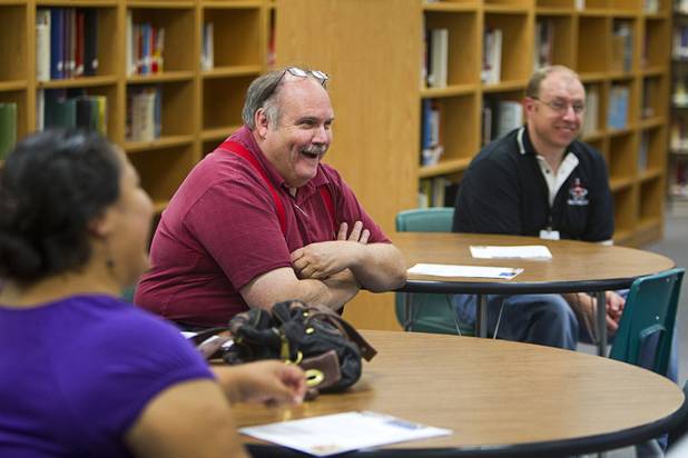 Dave Flatt, center, vice president of membership and marketing for the Nevada Parent Teachers Association (PTA), attends a Clark County School District informational meeting at the Bonanza High School library Tuesday, Sept. 18, 2012. CCSD officials answered questions related to a property tax initiative that will be on the ballot in November. The six-year capital levy, if approved, will raise $669 million for high-need school maintenance and renovations. 