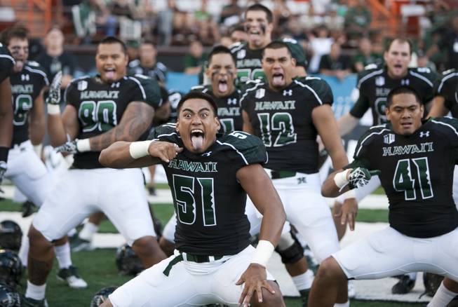 Hawaii linebacker Lance Williams (center) and his teammates perform a "haka" before the start of the the Warriors' 54-2 victory against Lamar on Saturday, Sept. 15, 2012, in Honolulu.
