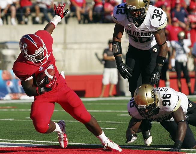 Fresno State's Robbie Rouse falls into the end zone for one of his four rushing touchdowns against Colorado in the Bulldogs' 69-14 victory on Saturday, Sept. 15, 2012, in Fresno, Calif.