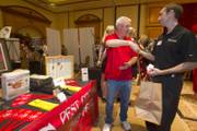 George Botta, left,operations manager for JS Pest Control talks with Chris Baden of Heartland, a payment technology company during a networking mixer at Texas Station Wednesday, Sept. 19, 2012. STEVE MARCUS