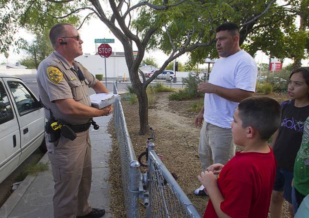 Darryl Duncan, a Clark County animal control officer, talks with Javier Valencia at Valencia's home Thursday Sept. 20, 2012. Duncan was responding to a report about a dog at that address that had tried to bite someone but Valencia said the dog did not belong to him and that he had already taken the dog to the shelter.