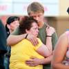 Amy Darrow and her son Jeremy Darrow hug before a candle light vigil Thursday, Sept. 20, 2012 for people who were killed and injured when Gary Lee Hosey Jr. drove into a bus stop a week earlier. Amy Darrow was a co-worker of Hyon Cooley's, who was killed in the crash.