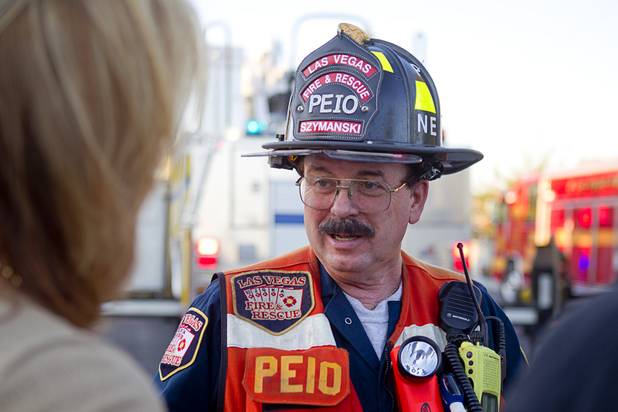 Las Vegas Fire and Rescue public information officer Tim Szymanski briefs reporters on a fire that damaged six homes in a neighborhood near Washington Avenue and Pecos Road Sunday, Sept. 23, 2012. Firefighters from the City of Las Vegas Fire Department, Clark County Fire Department, North Las Vegas Fire Department responded to fight the fires. Four people suffered injuries. One cat was killed.