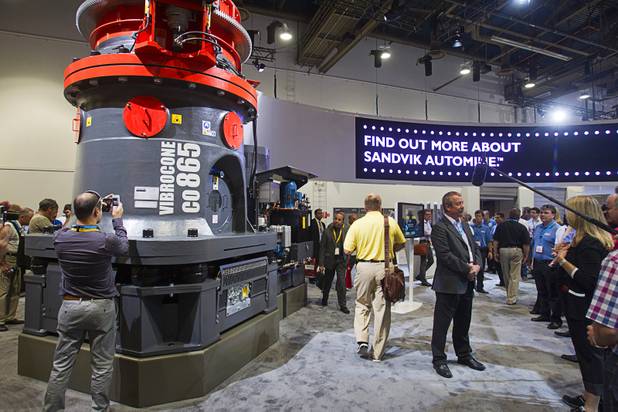 Gary Hughes, right, president of Sandvik Mining, is interviewed after unveiling a new energy-efficient crusher/grinder, left, during the MINExpo International 2012 trade show at the Las Vegas Convention Center Monday, Sept. 24, 2012.