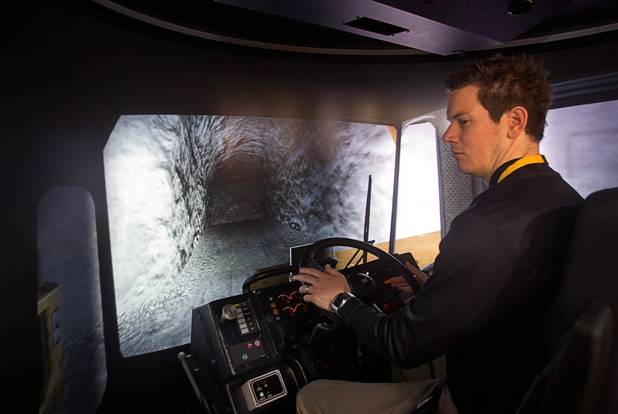 Chris Gell of Australian-based Immersive Technologies, demonstrates an underground mining truck simulator at the Caterpillar booth during the MINExpo International 2012 trade show at the Las Vegas Convention Center Monday, Sept. 24, 2012.