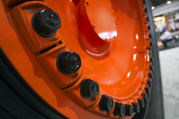 Lug nuts are shown on the wheel of a Hitachi mining truck during the MINExpo International 2012 trade show at the Las Vegas Convention Center Monday, Sept. 24, 2012. The company unveiled a new energy-efficient crusher/grinder at the show.