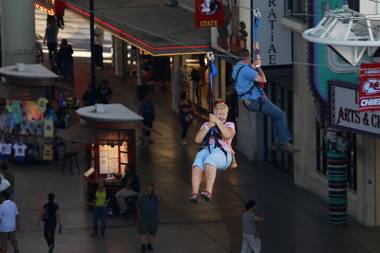 People enjoy the Flightlinez zip line at Fremont Street Experience on Wednesday, Sept. 26, 2012.