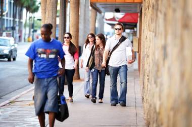 Zappos employees walk from Zappos’ temporary offices on Carson Avenue to the parking garage on Stewart Avenue in downtown Las Vegas on Wednesday, Sept. 26, 2012.