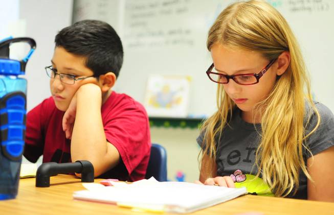 Wright Elementary School fourth graders Lillian Prince, 9, and Abraham Arias, 9, work on a writing assignment on Wednesday, Sept. 26, 2012. 
