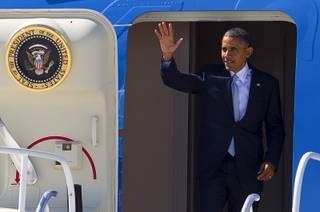 President Barack Obama waves as he arrives at McCarran International Airport Sunday, Sept. 30, 2012. Obama will attend a campaign rally then stay in Henderson as he prepares for his first debate with Republican presidential candidate Mitt Romney. The debate will be held in Colorado Wednesday.