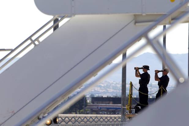 A security detail scans the horizon as they wait for President Barack Obama to arrive at McCarran International Airport Sunday, Sept. 30, 2012. Obama will attend a campaign rally then stay in Henderson as he prepares for his first debate with Republican presidential candidate Mitt Romney. The debate will be held in Colorado Wednesday.