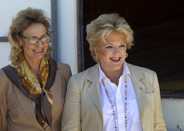 Marybel Batjer, left, vice president for public policy and corporate social responsibility at Caesars Entertainment, and Las Vegas Mayor Carolyn Goodman wait to greet President Barack Obama as he arrives at McCarran International Airport on Sunday, Sept. 30, 2012. 