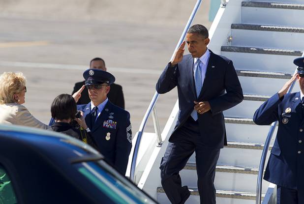 President Barack Obama salutes as he deplanes from Air Force One at McCarran International Airport Sunday, Sept. 30, 2012. Obama will attend a campaign rally then stay in Henderson as he prepares for his first debate with Republican presidential candidate Mitt Romney. The debate will be held in Colorado Wednesday.
