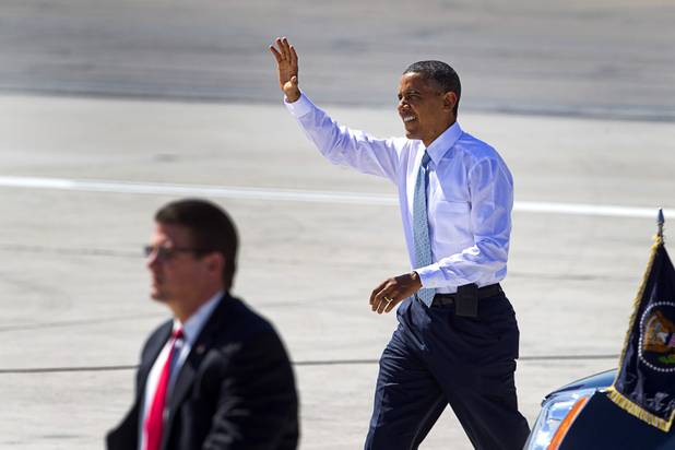 President Barack Obama waves to guests after arriving at McCarran International Airport Sunday, Sept. 30, 2012. Obama will attend a campaign rally then stay in Henderson as he prepares for his first debate with Republican presidential candidate Mitt Romney. The debate will be held in Colorado Wednesday.