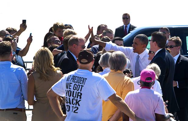 President Barack Obama gives a high-five to a boy after arriving at McCarran International Airport Sunday, Sept. 30, 2012. Obama will attend a campaign rally then stay in Henderson as he prepares for his first debate with Republican presidential candidate Mitt Romney. The debate will be held in Colorado Wednesday.