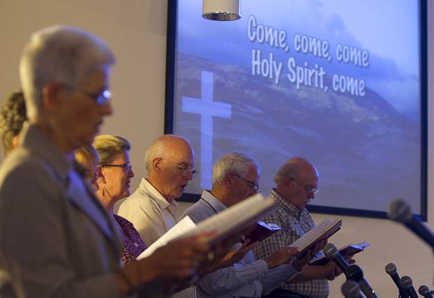 Choir members, including John Wallin, center, sing at New Song Church in Henderson Sunday, Sept. 30, 2012.