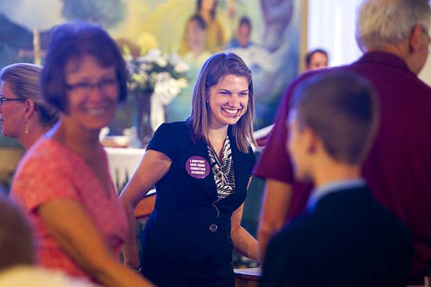 Intern Pastor Kaitlyn Ferguson mixes with members the church during a greeting time at New Song Church in Henderson Sunday, Sept. 30, 2012.