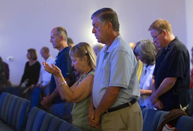 Members of the congregation pray during service at New Song Church in Henderson Sunday, Sept. 30, 2012.