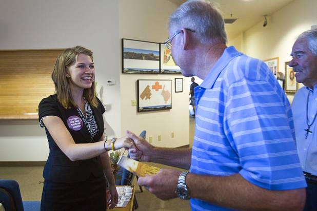 Intern Pastor Kaitlyn Ferguson greets congregation members after her first morning of preaching at New Song Church in Henderson Sunday, Sept. 30, 2012.