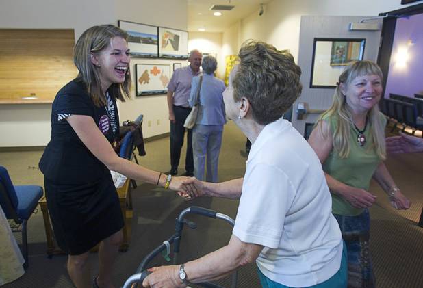 Intern Pastor Kaitlyn Ferguson greets congregation members after her first morning of preaching at New Song Church in Henderson Sunday, Sept. 30, 2012.