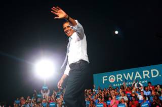 President Barack Obama waves to supporters while arriving at a campaign event Sunday, Sept. 30, 2012 at Desert Pines High School.