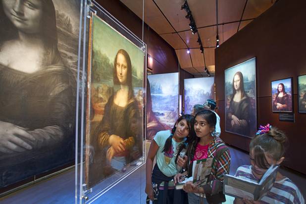 Hyde Park Middle School student, from left, Devika Bararia, Shreya Kamojjala, and Grace Goodwin look over an exhibit on the Mona Lisa during a visit to the "Da Vinci- The Genius" at the Imagine Gallery in the Venetian Monday, Oct. 1, 2012. This week, all Hyde Park sixth graders, who have been studying about  Leonardo Da Vinci for about a month, will visit the exhibit. The traveling exhibit has been extended through January, a representative said.