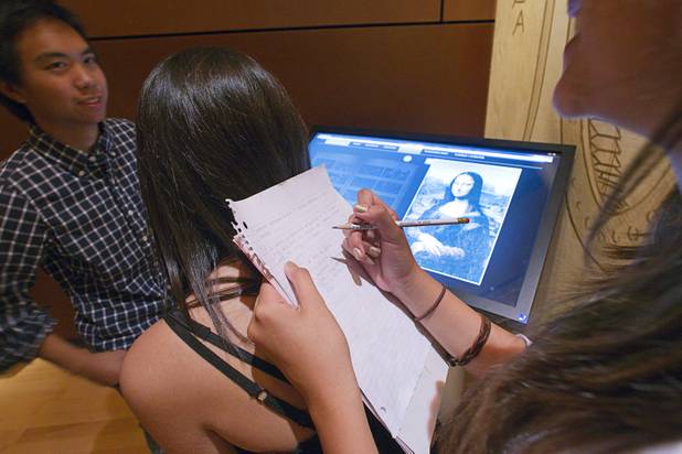 Jordan Miles, left, volunteers as desk for Erica Mershon during a visit to the "Da Vinci- The Genius" exhibit at the Imagine Gallery in the Venetian Monday, Oct. 1, 2012. Kyle Doria is at left. The students are from Olympian High School in San Diego. This week, all Hyde Park sixth graders, who have been studying about Leonardo Da Vinci for about a month, will visit the exhibit. The traveling exhibit has been extended through January, a representative said.