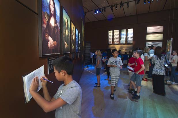 Hyde Park Middle School student Timothy Ryu makes a drawing of the Mona Lisa in his workbook during a visit to the "Da Vinci- The Genius" exhibit at the Imagine Gallery in the Venetian Monday, Oct. 1, 2012. This week, all Hyde Park sixth graders, who have been studying about  Leonardo Da Vinci for about a month, will visit the exhibit. The traveling exhibit has been extended through January, a representative said.