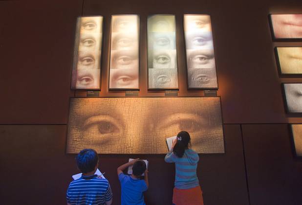 Hyde Park Middle School students fill out workbooks in front of a display of Mona Lisa's eyes during a visit to the "Da Vinci- The Genius" exhibit at the Imagine Gallery in the Venetian Monday, Oct. 1, 2012. This week, all Hyde Park sixth graders, who have been studying about  Leonardo Da Vinci for about a month, will visit the exhibit. The traveling exhibit has been extended through January, a representative said.