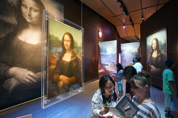 Hyde Park Middle School students look over an exhibit on the Mona Lisa during a visit to the "Da Vinci- The Genius" at the Imagine Gallery in the Venetian Monday, Oct. 1, 2012. This week, all Hyde Park sixth graders, who have been studying about  Leonardo Da Vinci for about a month, will visit the exhibit. The traveling exhibit has been extended through January, a representative said.