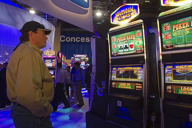 Dan Dobkin of Deadwood, S.D. watches as a bonus game is played on an IGT Western Stars slot machine during the Global Gaming Expo (G2E) at the Sands Expo Center Tuesday, Oct. 2, 2012.