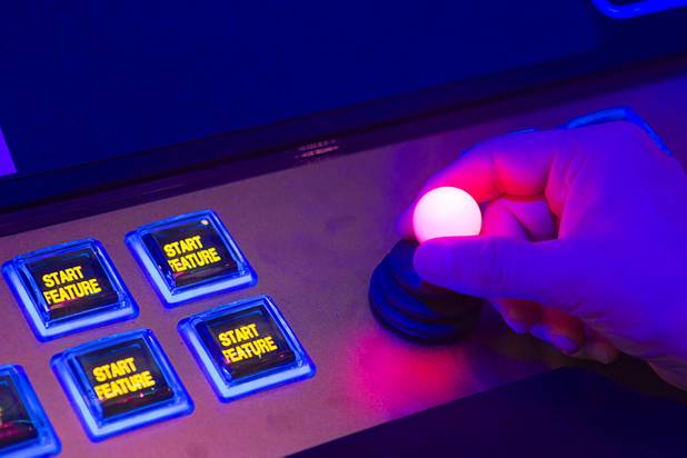 A man operates a joystick for a skill-based bonus game on an IGT slot machine during the Global Gaming Expo (G2E) at the Sands Expo Center on Tuesday, Oct. 2, 2012.