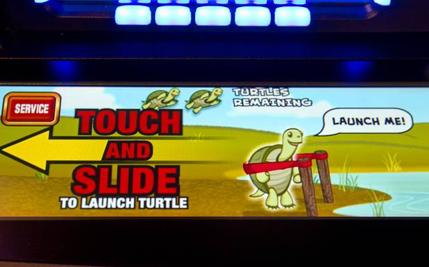 A Bally Technologies interactive bonus game that arbitrarily appears during play is displayed below a slot machine screen during the Global Gaming Expo (G2E) at the Sands Expo Center Tuesday, Oct. 2, 2012.
