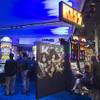 People try out the new KISS-themed slot machine at the WMS Gaming booth during the Global Gaming Expo (G2E) at the Sands Expo Center Tuesday, Oct. 2, 2012.