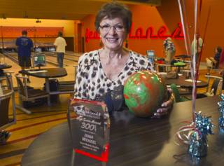 Bowler Irma Wenzel, 79, poses by her trophy during practice at Red Rock Lanes in the Red Rock Resort Wednesday, Oct. 3 2012. Wenzel was recognized Wednesday for bowling a perfect game at the bowling center on Sept. 26.