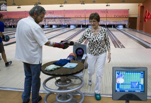 Bowler Irma Wenzel, 79, is congratulated by Gary emerson after picking up a spare at Red Rock Lanes in the Red Rock Resort Wednesday, Oct. 3 2012. Wenzel was recognized Wednesday for bowling a perfect game at the bowling center on Sept. 26.