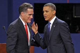 Republican presidential nominee Mitt Romney and President Barack Obama talk after their first presidential debate at the University of Denver on Wednesday, Oct. 3, 2012.