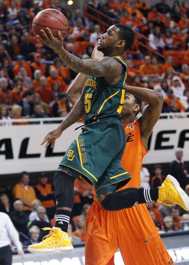 Baylor guard Pierre Jackson, left, goes up for a shot in front of Oklahoma State guard Le'Bryan Nash, right, in the second half of an NCAA college basketball game in Stillwater, Okla., Saturday, Feb. 4, 2012. Baylor won 64-60.
