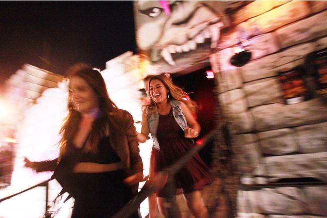 Shelby Sanchez and friends run screaming from one of the Freakling Brothers Trilogy of Terror haunted houses Saturday, Oct. 6, 2012.