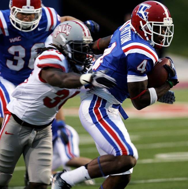 Louisiana Tech's Quinton Patton (4) looks for open space as UNLV's Sidney Hodge (36) tries to stop him during their NCAA college football game on Saturday, Oct. 6, 2012, at the Joe Ailliet Stadium in Ruston, La.