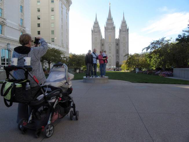 Brad and Jennifer Clower of Mountain Home, Idaho, pose with their children Oct. 5, 2012, outside the Mormon temple in downtown Salt Lake City. The Clowers will be visiting family and sightseeing during the semi-annual conference of The Church of Jesus Chris of Latter-day Saints this weekend, but they said they will record the conference sessions to watch later.