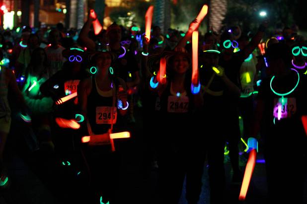 Participants take off from the start during the Glow Run 5k fun run Sunday, Oct. 7, 2012 in downtown Las Vegas.