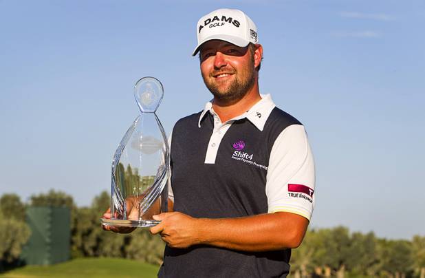 Former UNLV golfer Ryan Moore poses with his trophy after winning the 2012 Justin Timberlake Shriners Hospitals for Children Open at TPC Summerlin Sunday, Oct. 7, 2012.