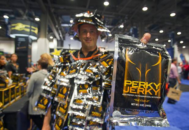 Perky Jerky founder Brian Levin, wearing a velcro suit covered with Perky Jerky, displays the "Five-0," 5-ounce package of his ultra-premium jerky during the annual National Association of Convenience Stores (NACS) trade show at the Las Vegas Convention Center Monday, Oct. 8, 2012.