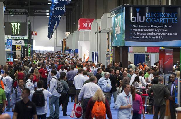 Attendees crown an aisle way during the annual National Association of Convenience Stores (NACS) trade show at the Las Vegas Convention Center Monday, Oct. 8, 2012.