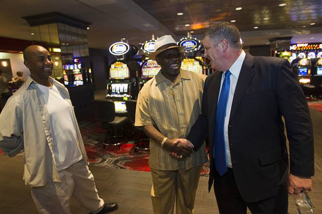 Derek Stevens, right, CEO of the D Las Vegas, greets friend Chuck William, center, and Dess Mebra at the D Las Vegas in downtown Las Vegas Tuesday, Oct. 9, 2012. The casino, formerly Fitzgeralds, is celebrating it's rebranding and renovation with festivities this weekend.