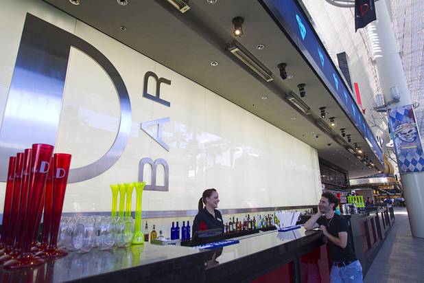 Flair bartender Erin Ferreira talks with a kiosk vendor at the D Las Vegas in downtown Las Vegas Tuesday, Oct. 9, 2012. The casino, formerly Fitzgeralds, is celebrating it's rebranding and renovation with festivities this weekend.