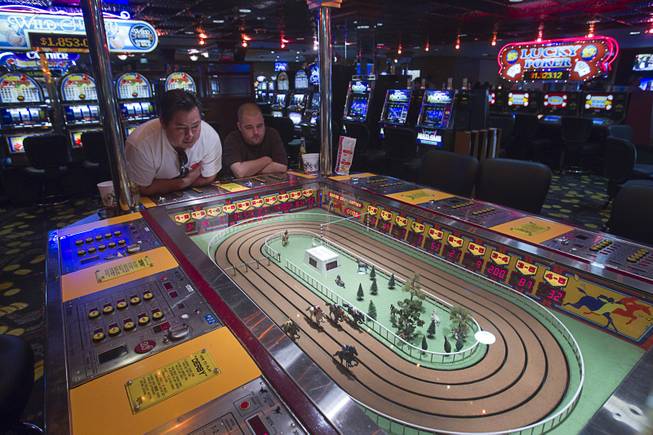 Jose Halse, left, and John Pecor of San Diego try out a Sigma Derby game on a "Vintage Vegas" casino floor at the D Las Vegas in downtown Las Vegas Tuesday, Oct. 9, 2012. The casino had to reapply to have the game approved in Nevada because the original approval had expired, said CEO Derek Stevens. The casino, formerly Fitzgeralds, is celebrating it's rebranding and renovation with festivities this weekend.