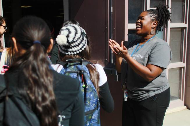 Communities in Schools coordinator Kalan Washington cheers students as they make their way to lunch at Bridger Middle School on Tuesday, Oct. 9, 2012.