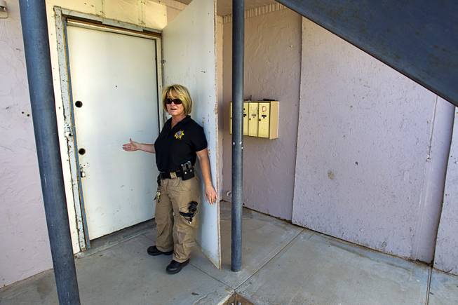 Metro Police Officer Virginia Griffin shows off an apartment door ...